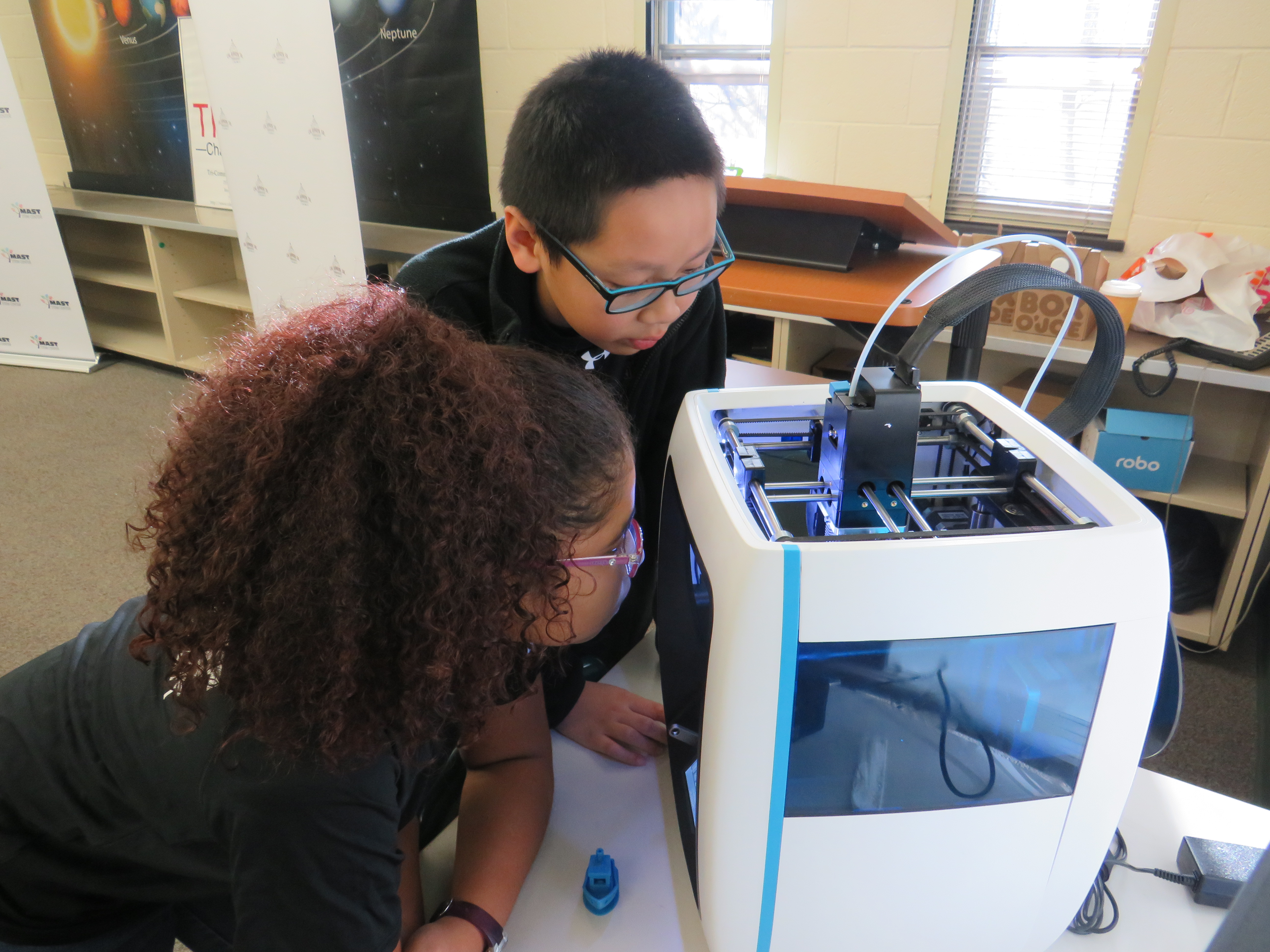 Students watching a 3D Printer in action