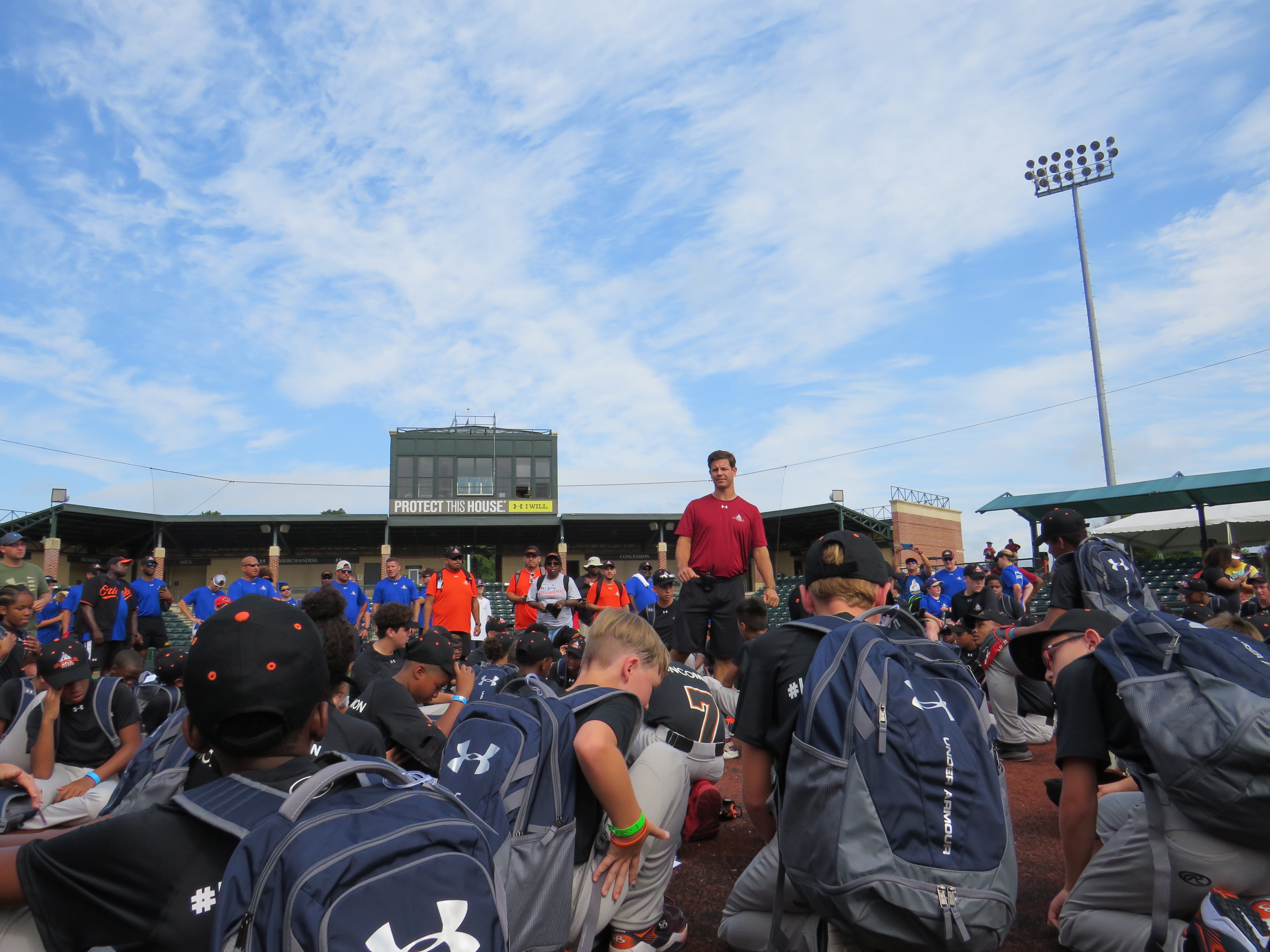 Campers hearing from coach Scott on the field