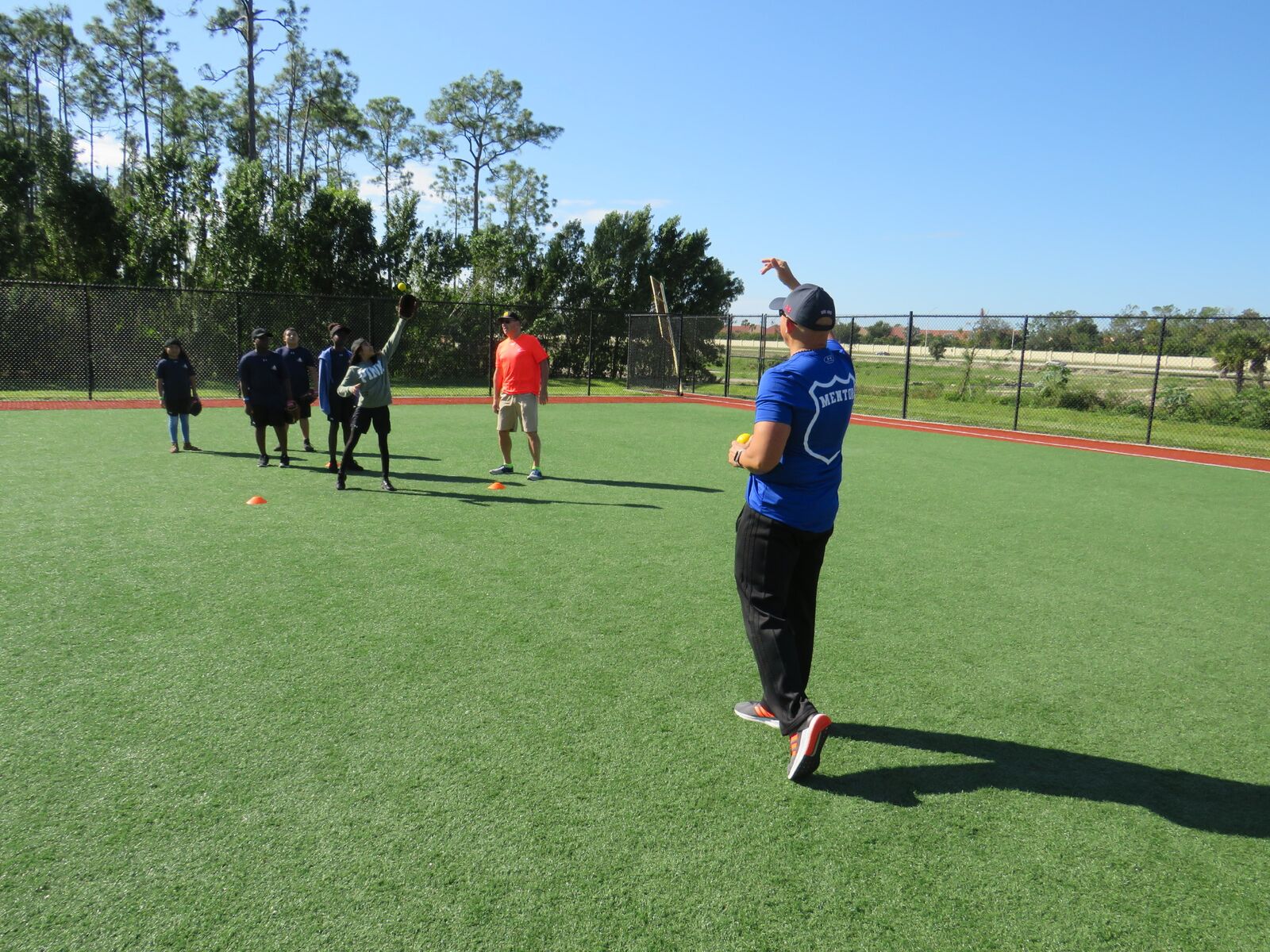 Lt. Greg Bueno working outfield drills with campers at the CRSF Naples Camp
