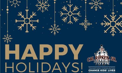 A picture of our holiday card with gold snowflakes on a blue background with the text "Happy Holidays"