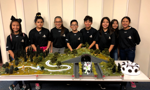 SpringSpirit youth with their winning STEM Competition entry prototype of an ecosystem with a highway running through it.